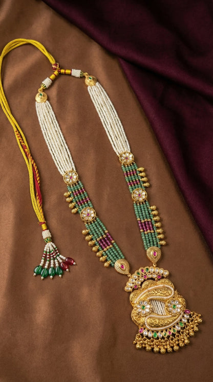 Close-up of intricate traditional craftsmanship on Nalima antique gold necklace pendant